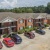 brick apartments with cars parked in front of it